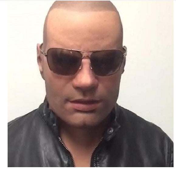 Man wearing sunglasses and a black leather jacket against a plain background
