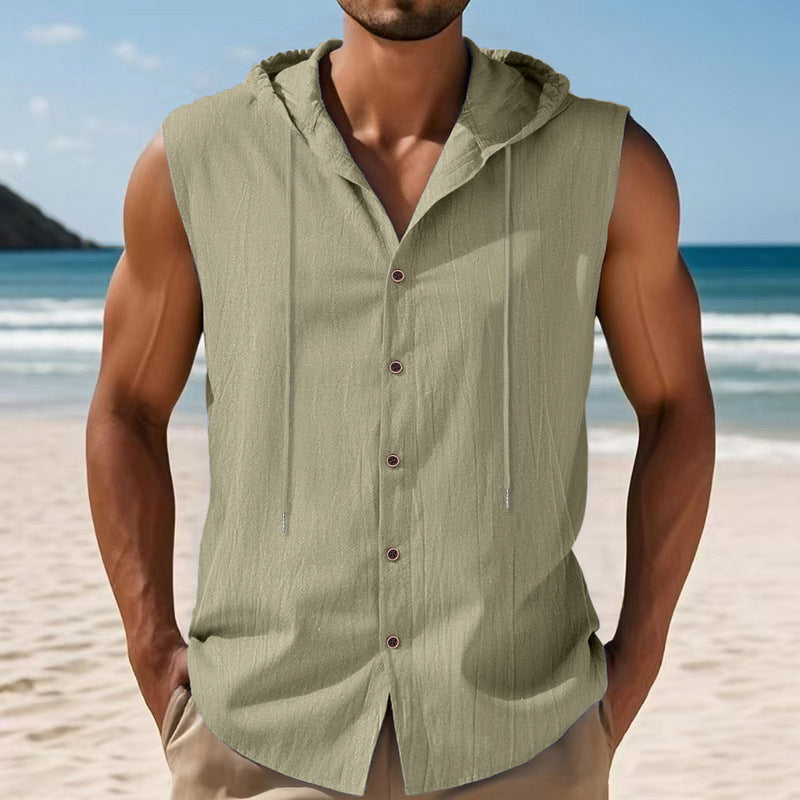 Man wearing a green sleeveless hoodie on a beach