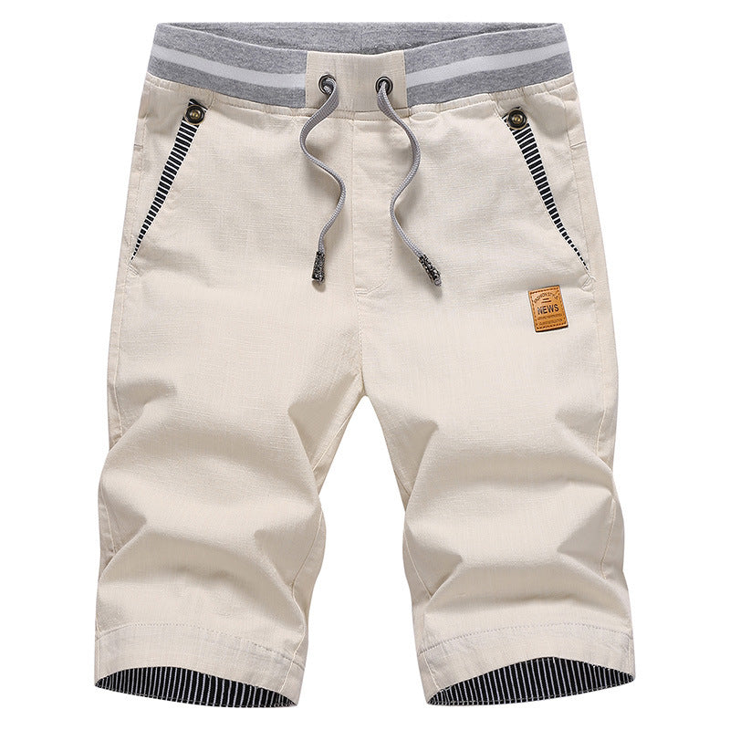 Beige shorts with a drawstring on a white background
