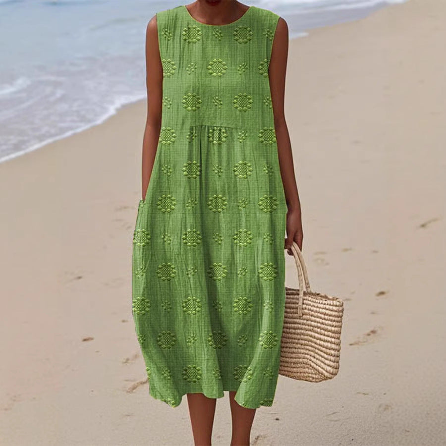 Woman in a green dress holding a straw bag on a beach