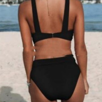 Person wearing a black bikini on a beach