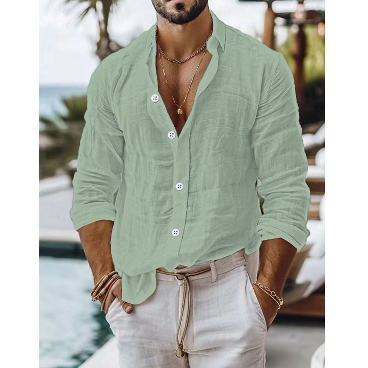 Man wearing a light green button-up shirt and beige pants by a poolside.