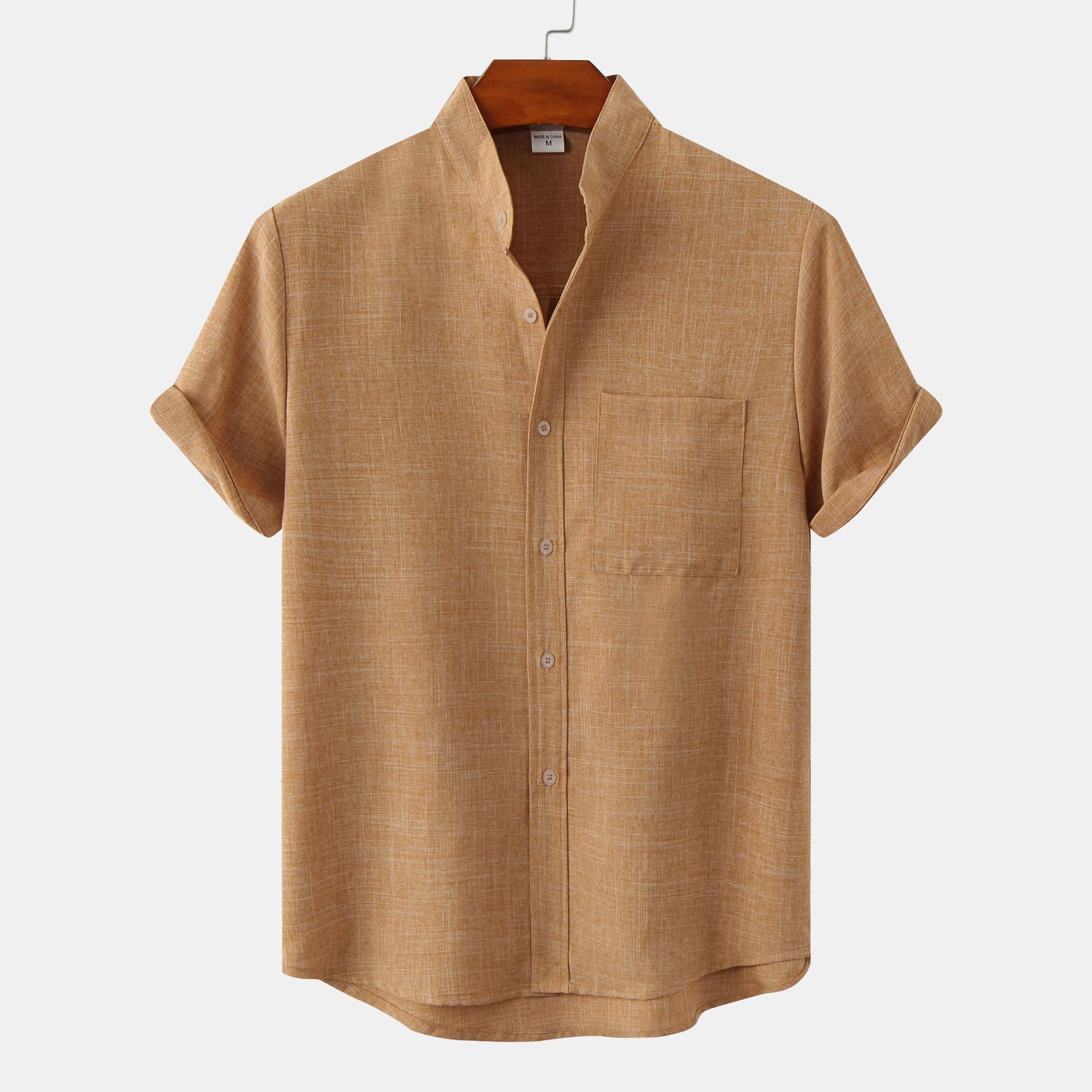 Brown short-sleeve shirt on a hanger against a white background