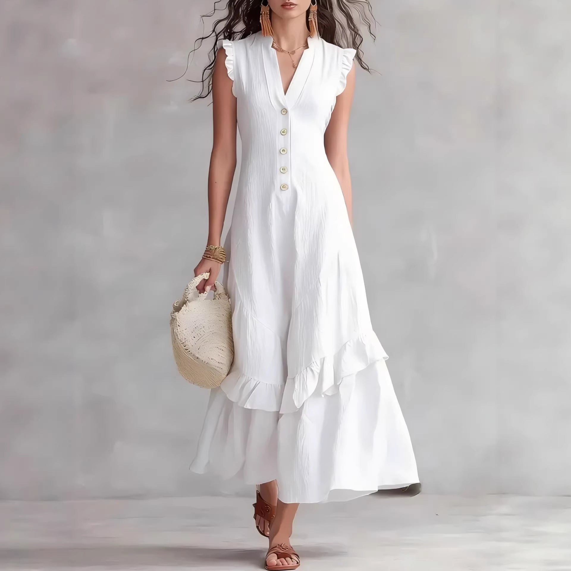 Woman wearing a white dress with ruffled sleeves and buttons, holding a beige handbag against a plain background.
