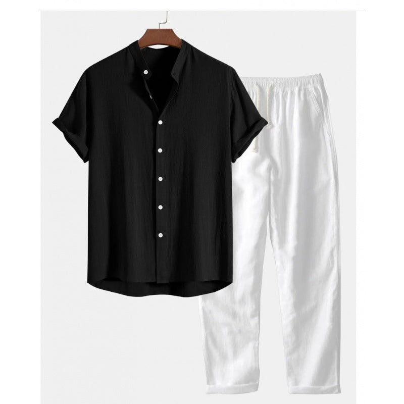Black shirt and white pants on a hanger against a white background