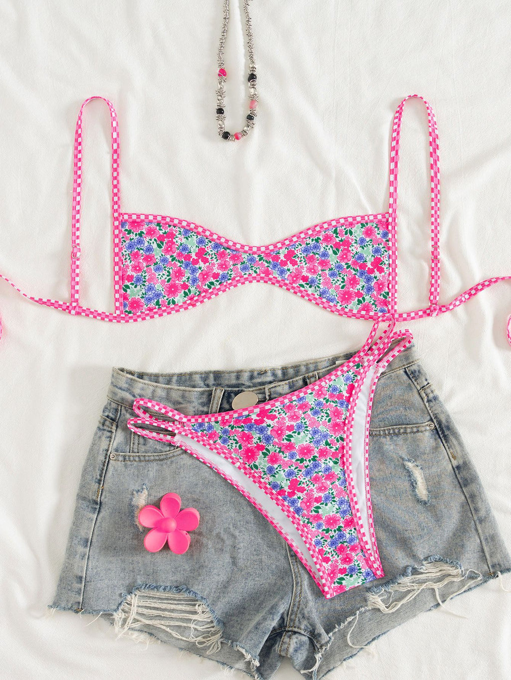 Floral bikini set with denim shorts on a white background
