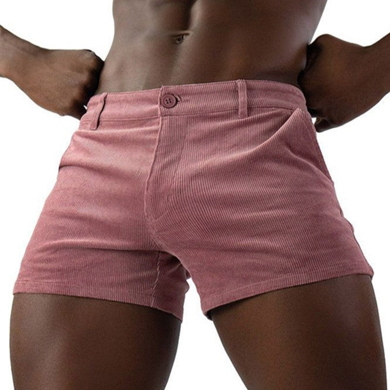 Person wearing pink shorts on a white background