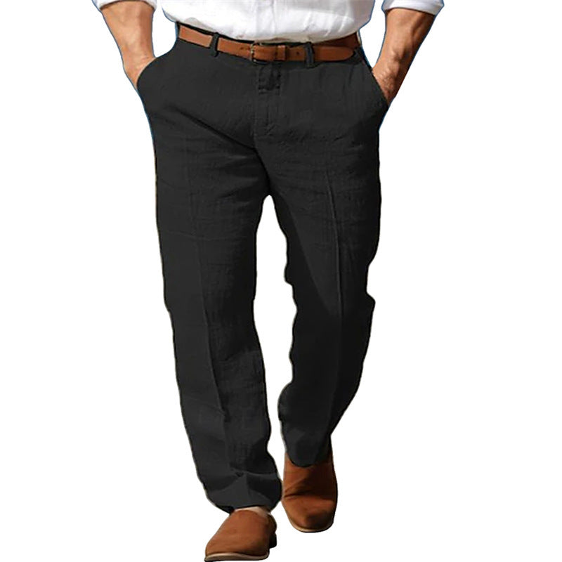 Person wearing black pants with a brown belt and shoes on a white background