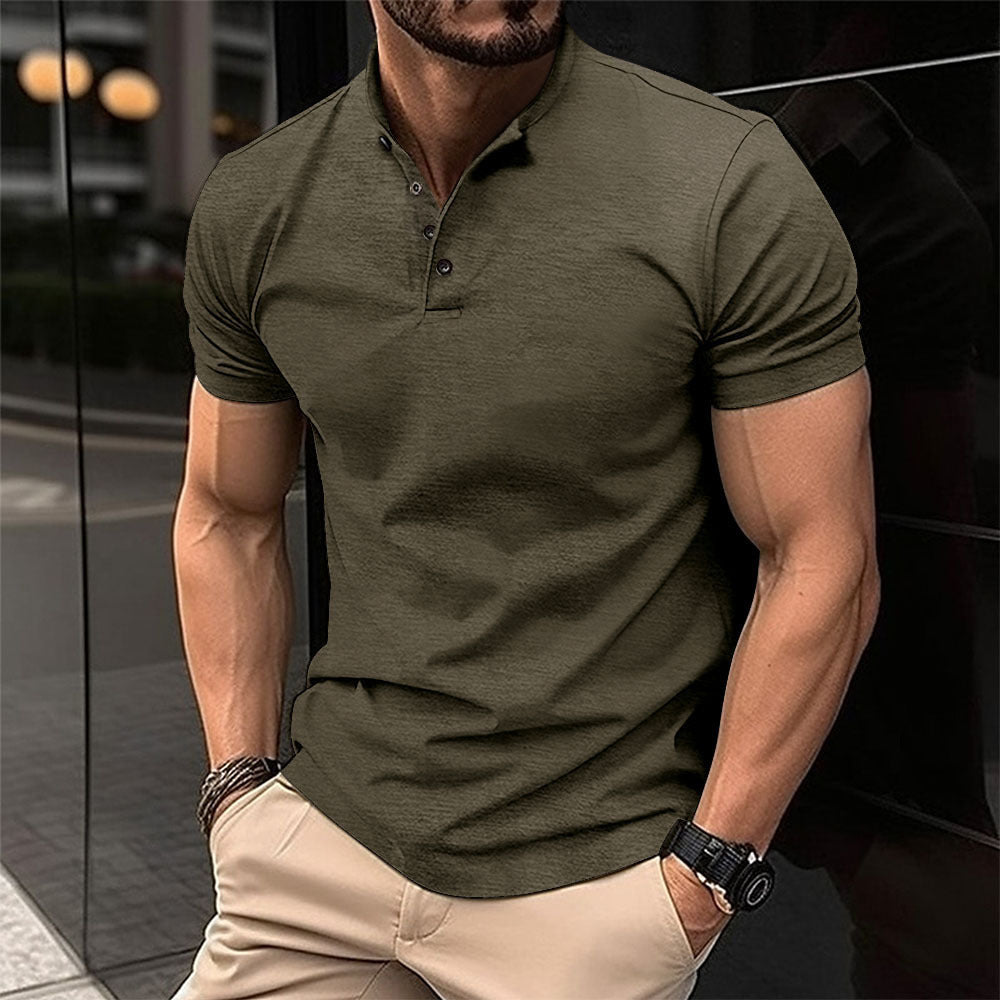 Man wearing a green polo shirt and beige pants in an urban setting