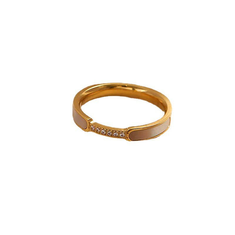 Gold ring with small diamonds on a white background