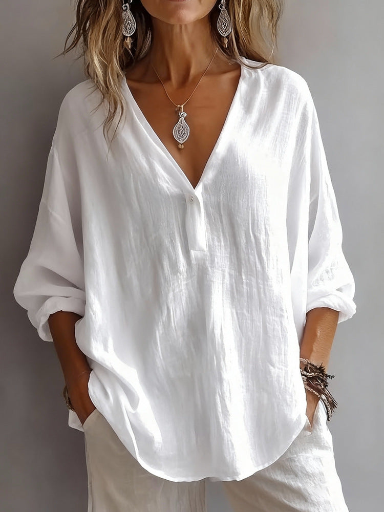 White oversized shirt worn by a person with a neutral background