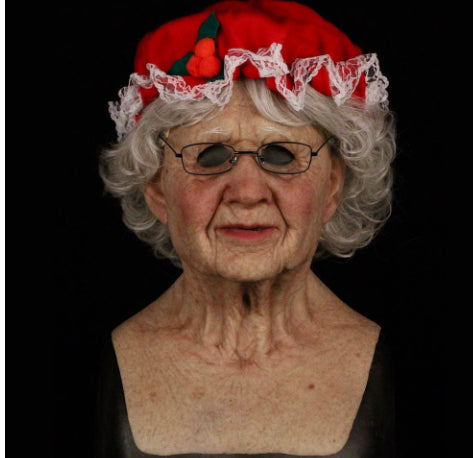 A realistic elderly woman bust with gray hair, wearing a red beret with white lace trim and a small red cherry decoration, photographed against a black background.
