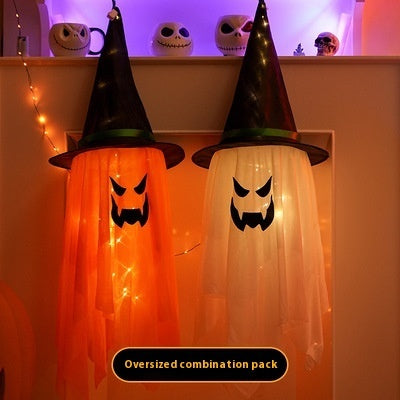 Two Halloween-themed ghosts with witch hats and string lights on a white background.