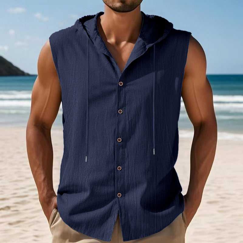 Man wearing a navy sleeveless shirt with buttons on a beach