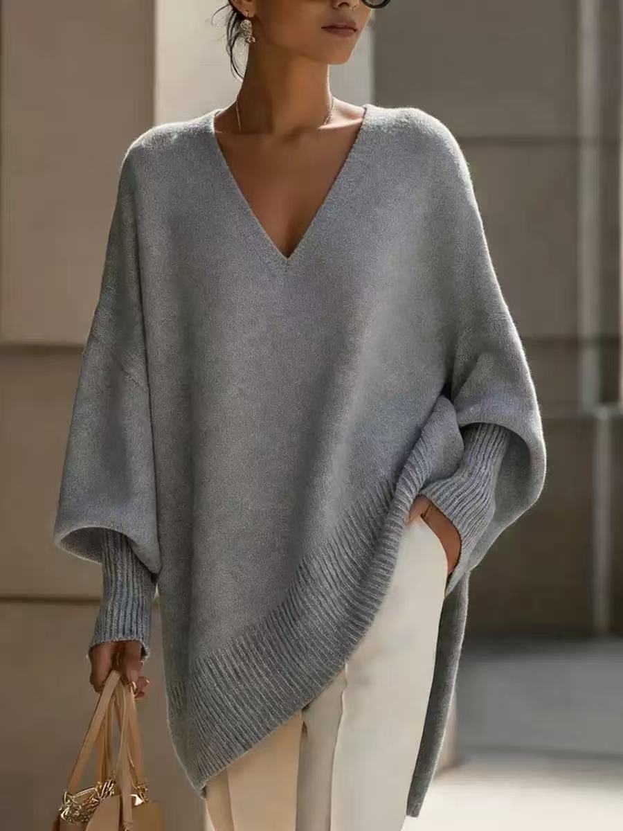 Person wearing a gray poncho in an indoor setting