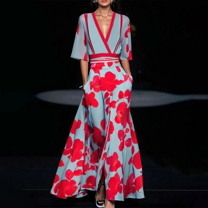 Woman wearing a floral dress with red and blue pattern on a dark background