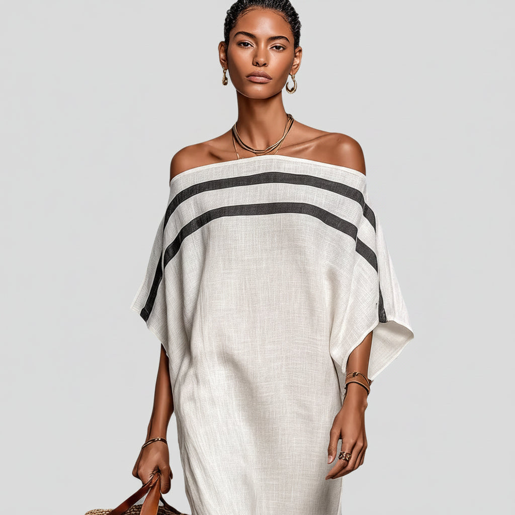 Woman wearing a white off-shoulder dress with black stripes on a white background