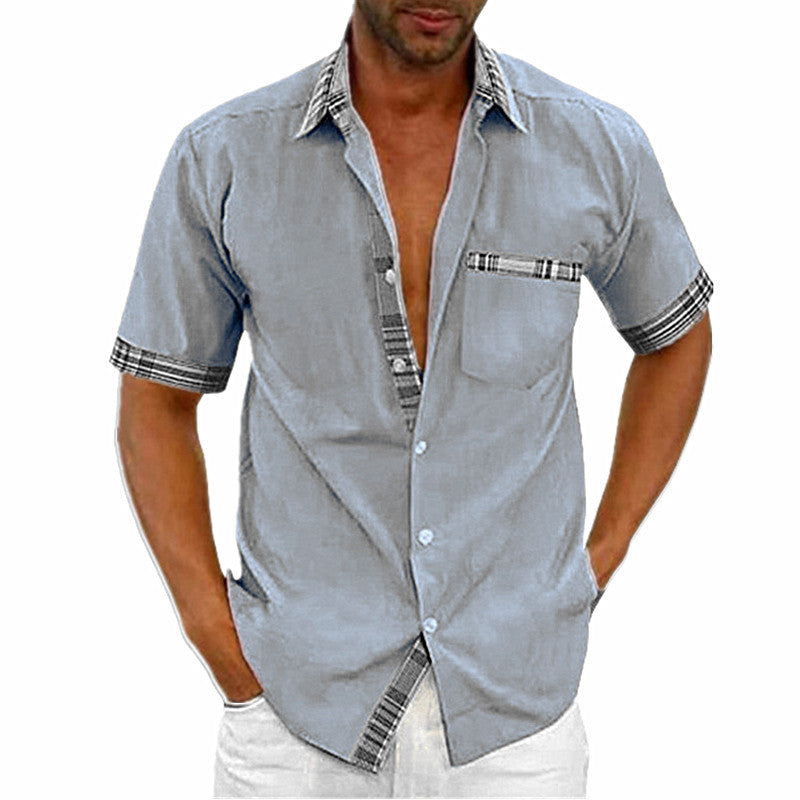 Man wearing a light blue short-sleeve shirt with plaid accents on a white background