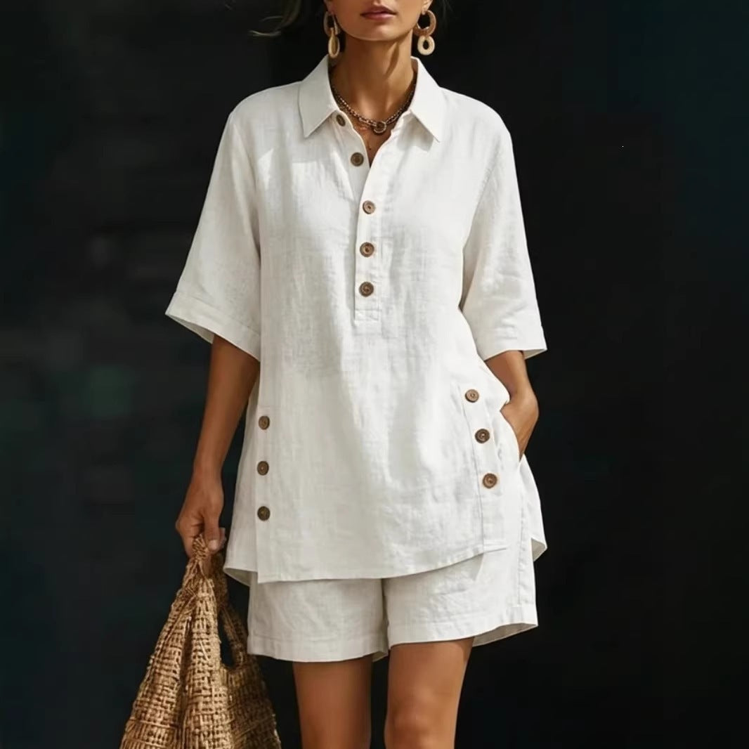 Woman wearing a white outfit with brown buttons against a dark background
