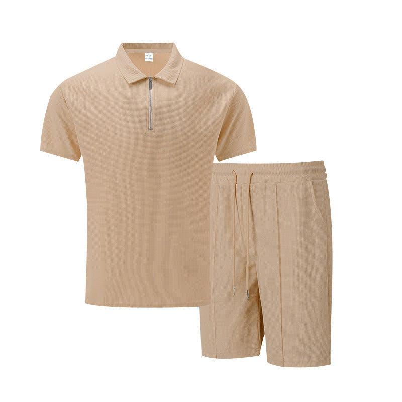 Beige polo shirt and shorts set on a white background