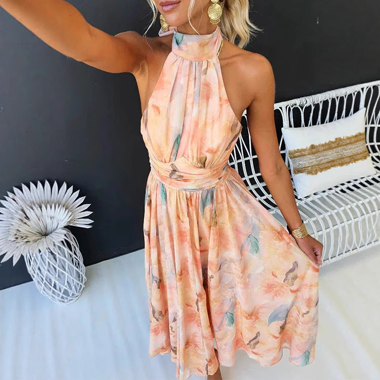 Woman wearing a floral dress in a room with a black wall and white furniture.