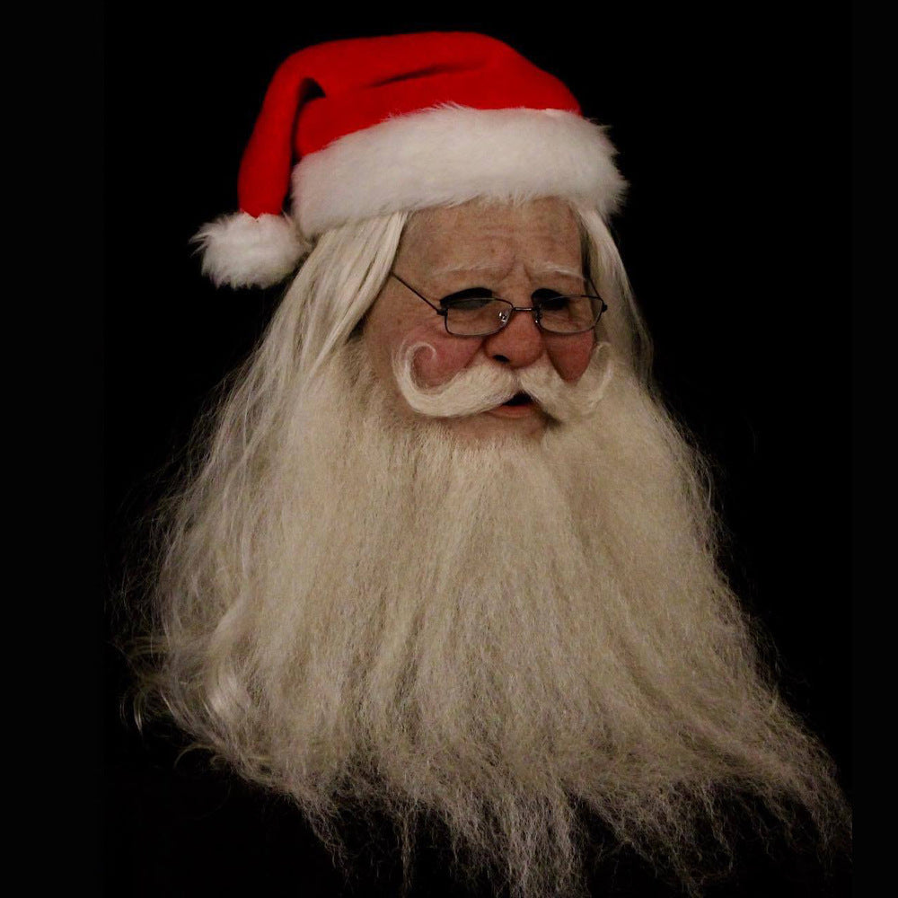 Close-up of a Santa Claus figure with a red hat and white beard on a black background