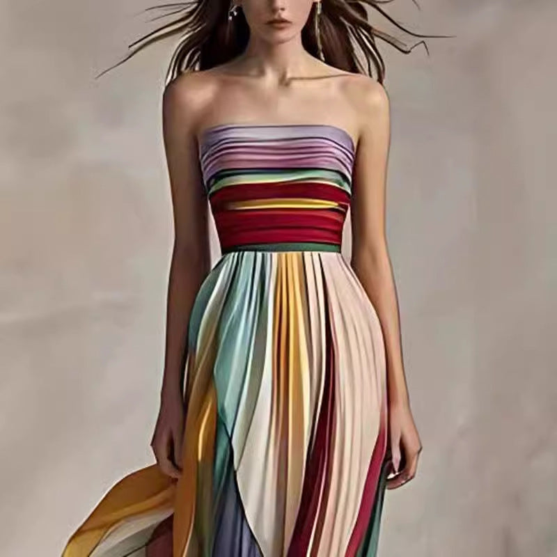 Woman wearing a strapless, multicolored dress against a neutral background