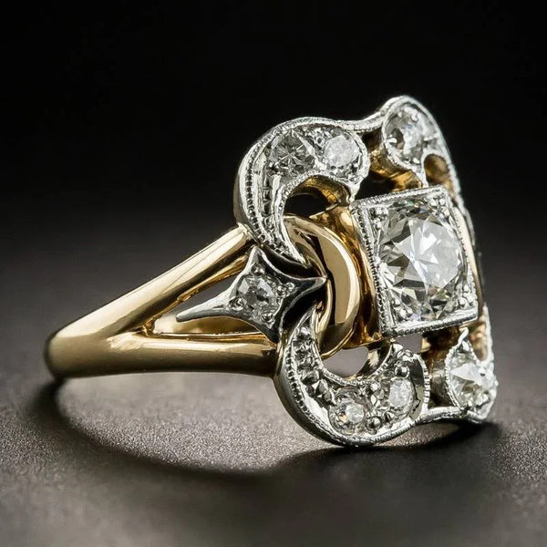 Gold and silver ring with diamond accents on a dark background