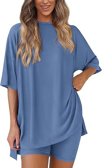 Woman wearing a blue oversized t-shirt and shorts set on a white background