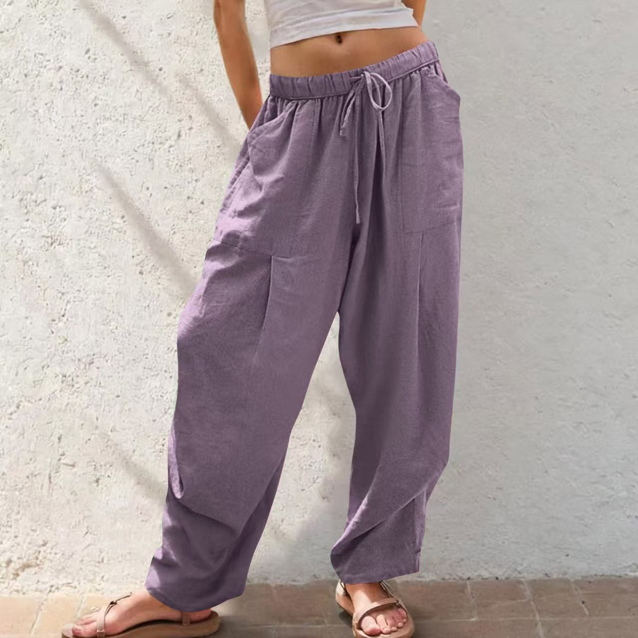 Person wearing purple wide-leg pants against a light background