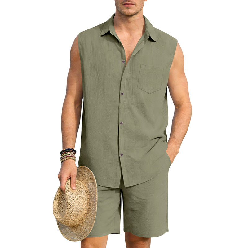 Man wearing a green sleeveless shirt and shorts holding a straw hat on a white background