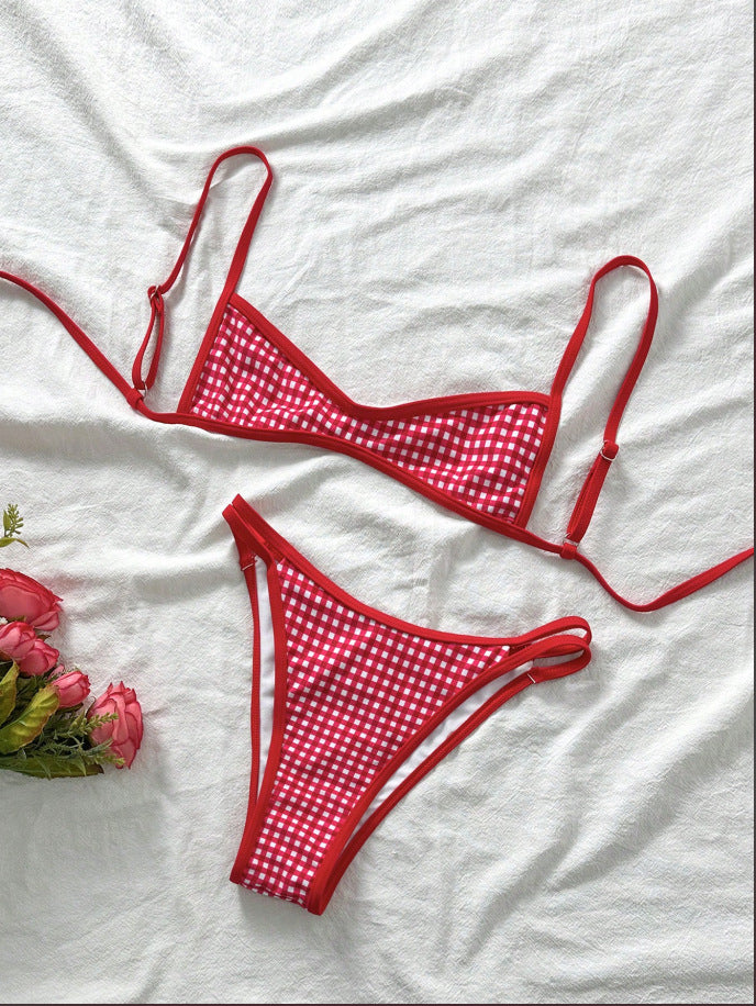 Red bikini set with white polka dots on a white fabric background