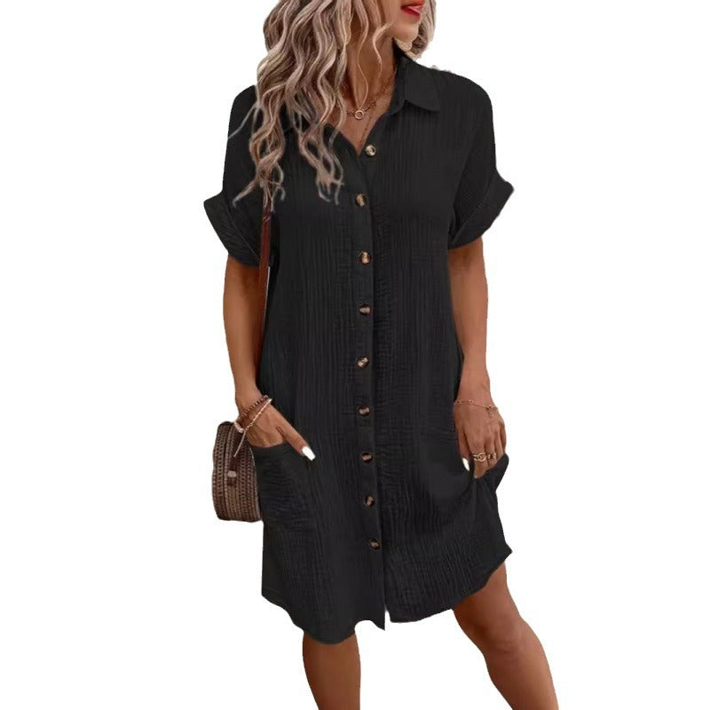 Woman wearing a black button-up dress on a white background