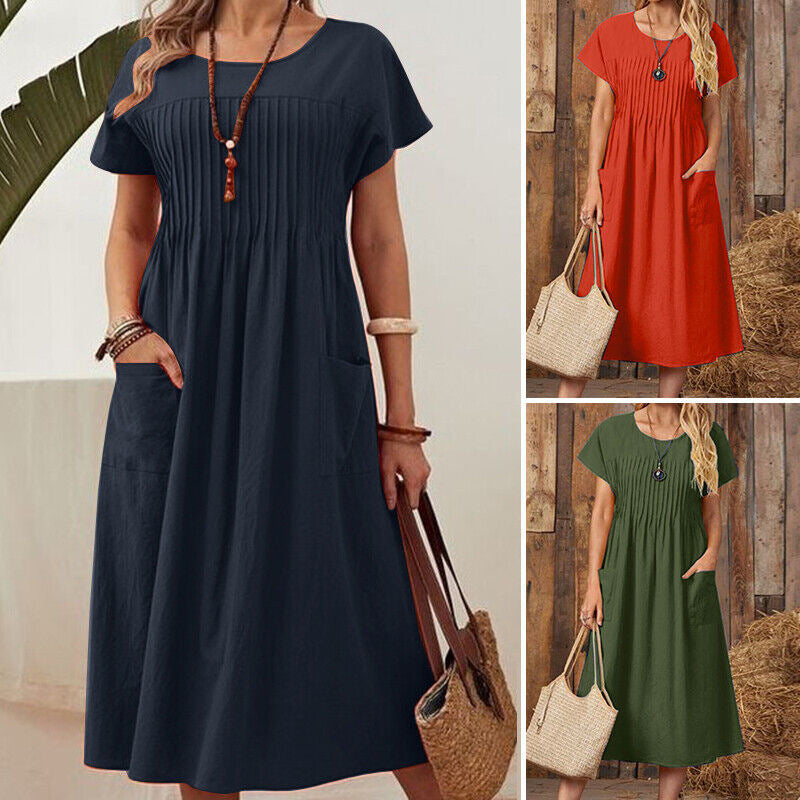 Three women wearing navy, red, and green dresses with a wooden background.