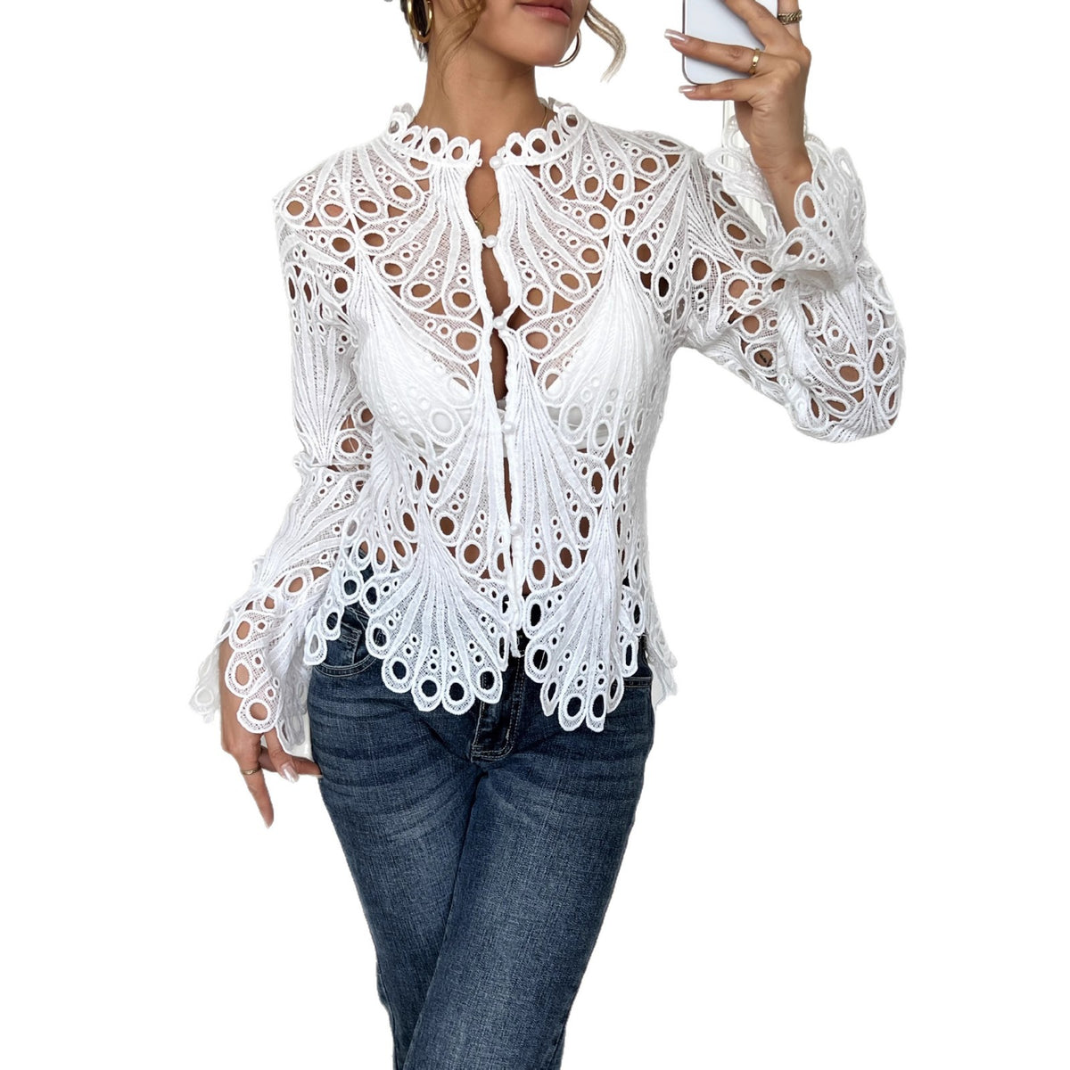 White lace blouse worn by a person on a white background