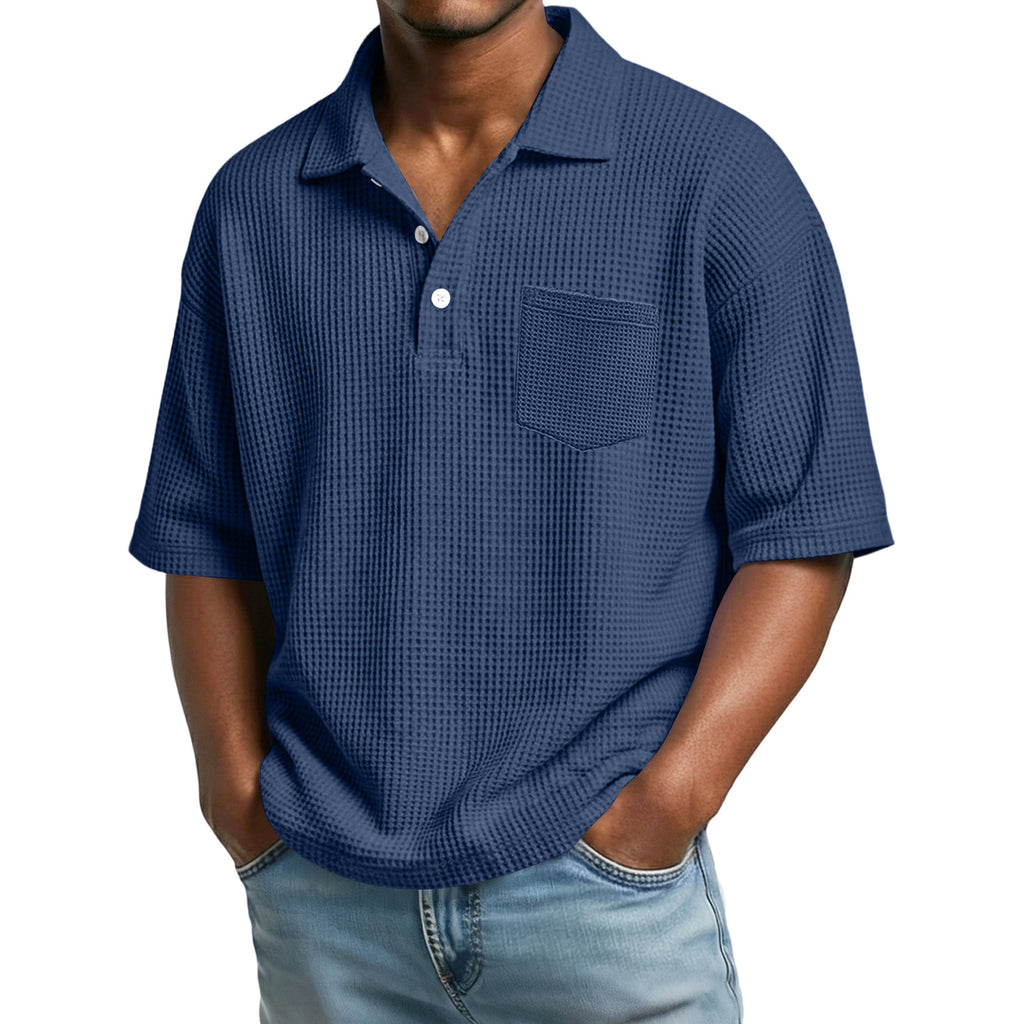 Man wearing a blue textured polo shirt on a white background