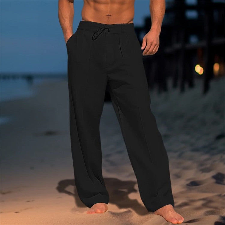 Person wearing black pants on a beach at night