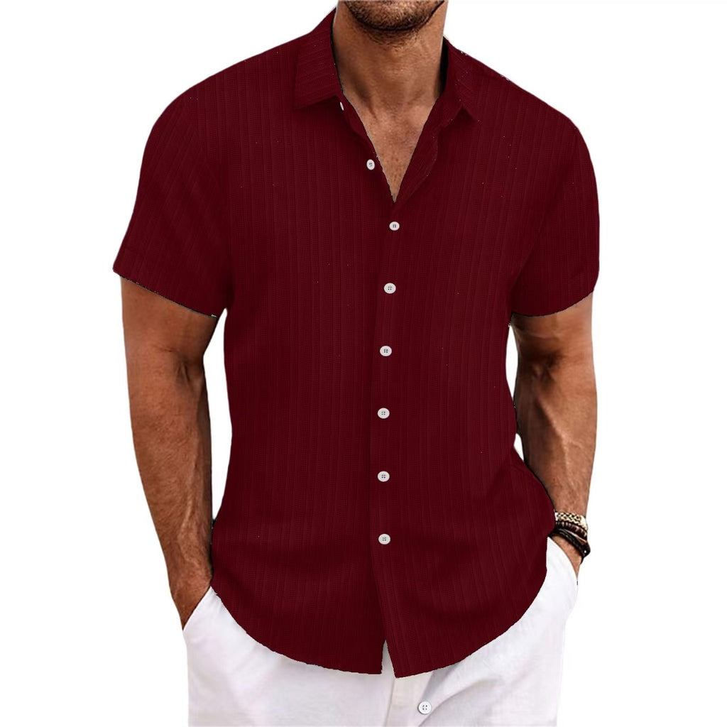 Man wearing a maroon short-sleeve shirt with white buttons on a white background