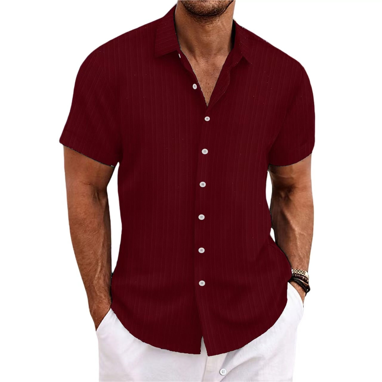 Man wearing a maroon short-sleeve shirt with white buttons on a white background