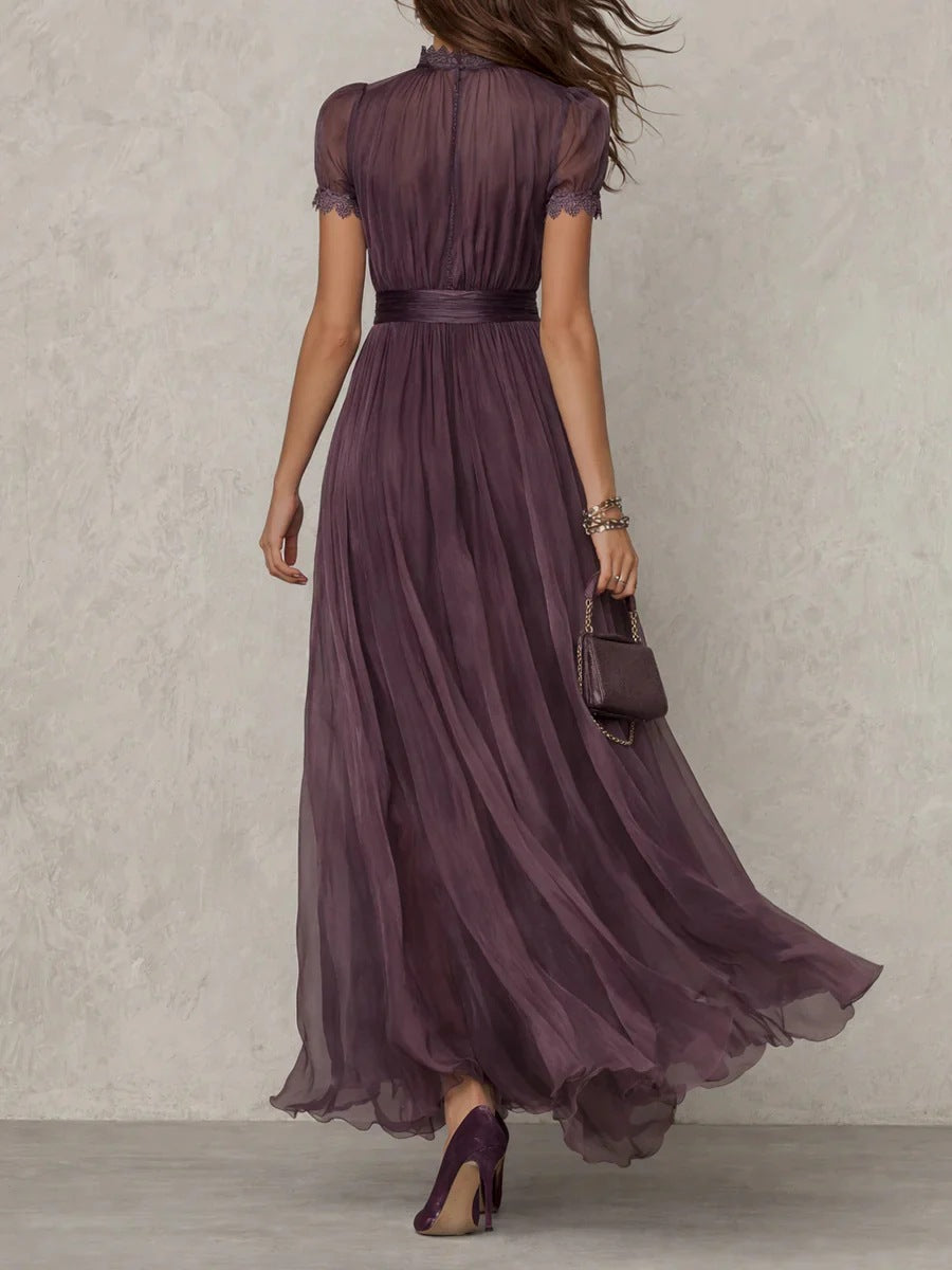 Woman wearing a long purple dress against a neutral background