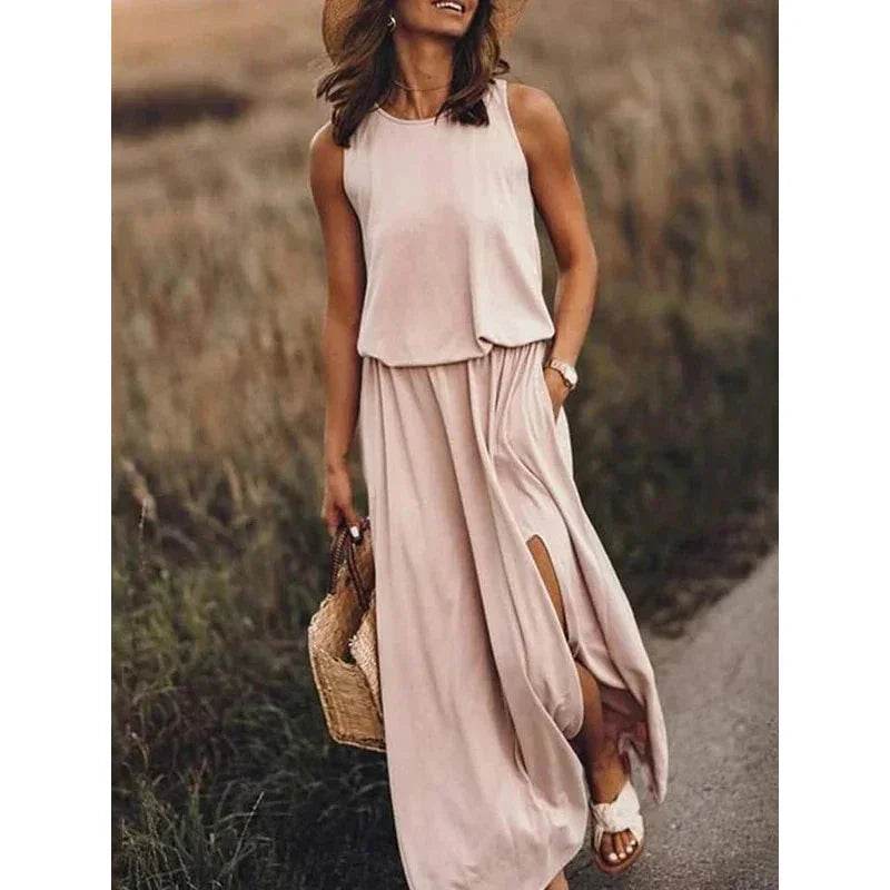 Woman in a sleeveless beige maxi dress with slit, straw hat, and bag outdoors, ZA-Zola fashion