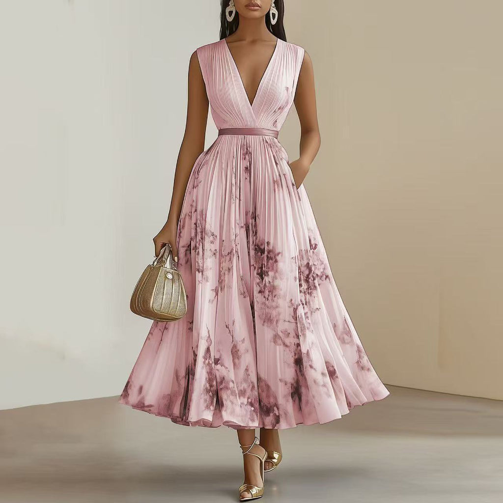 Woman wearing a pink floral dress holding a handbag against a neutral background