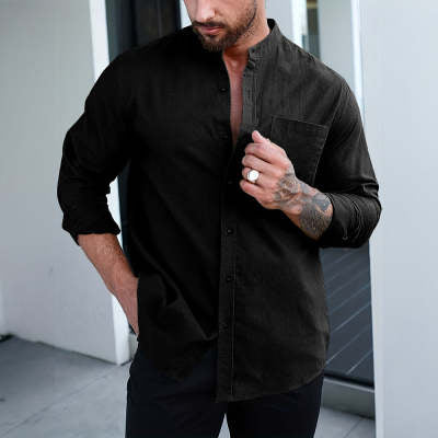 Man wearing a black shirt with a neutral background