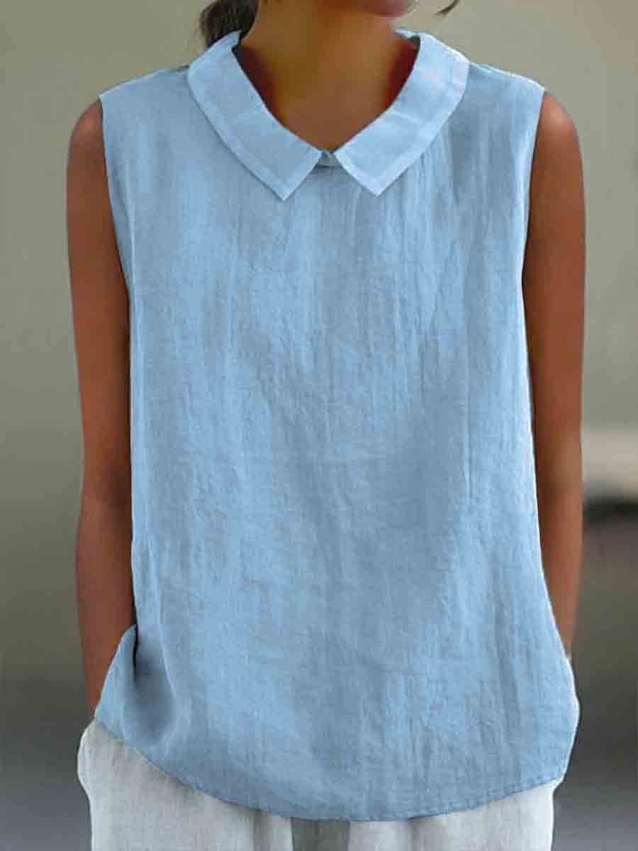 Light blue sleeveless shirt with a white collar worn by a person against a neutral background