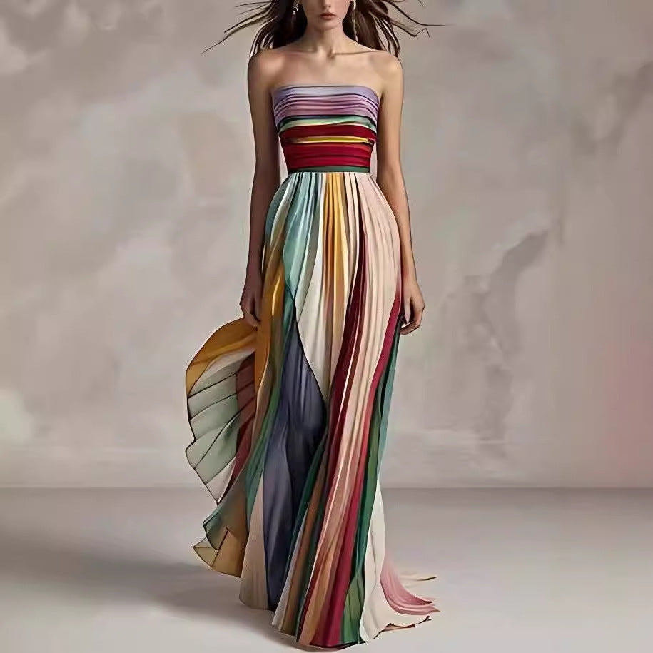 Woman wearing a strapless, long, multicolored dress against a neutral background