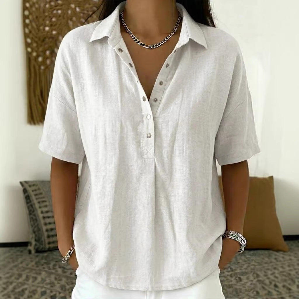 Person wearing a white short-sleeve shirt in an indoor setting