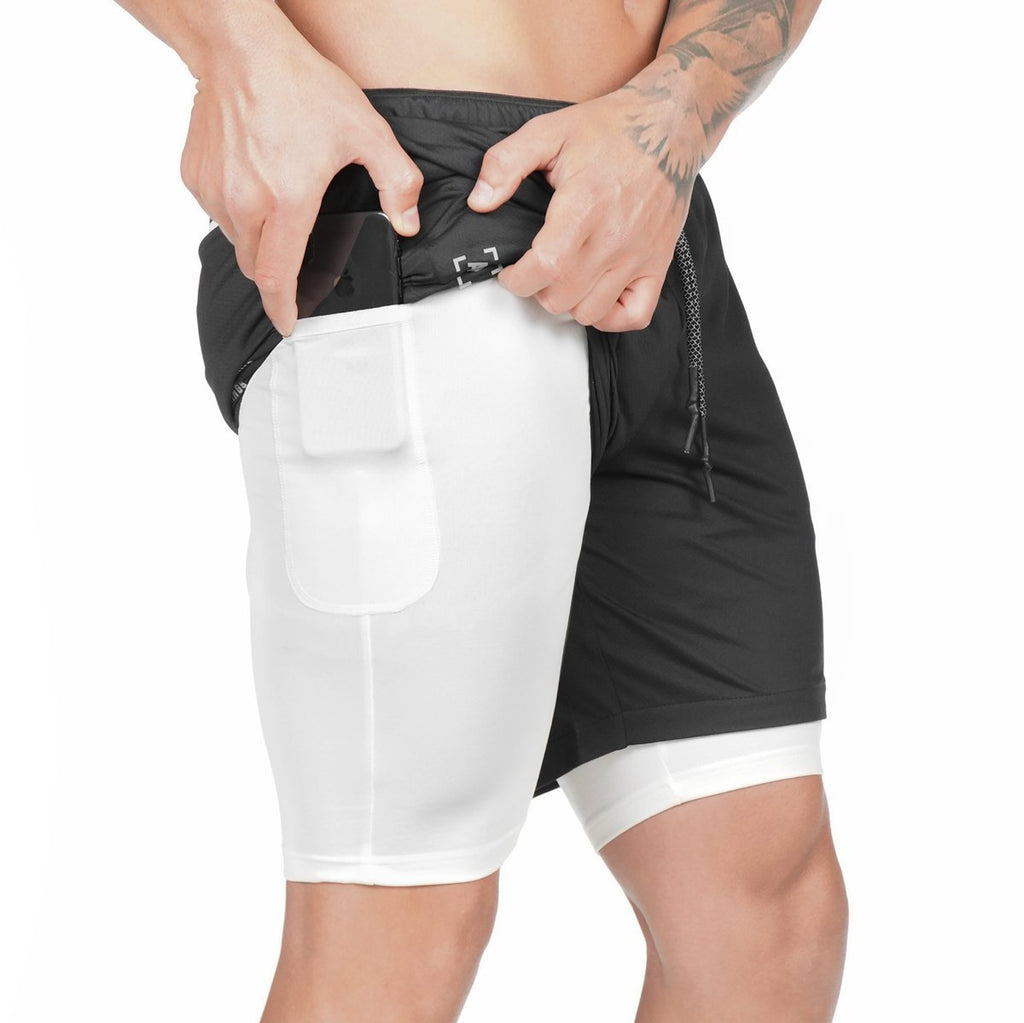 Person wearing black and white athletic shorts on a white background