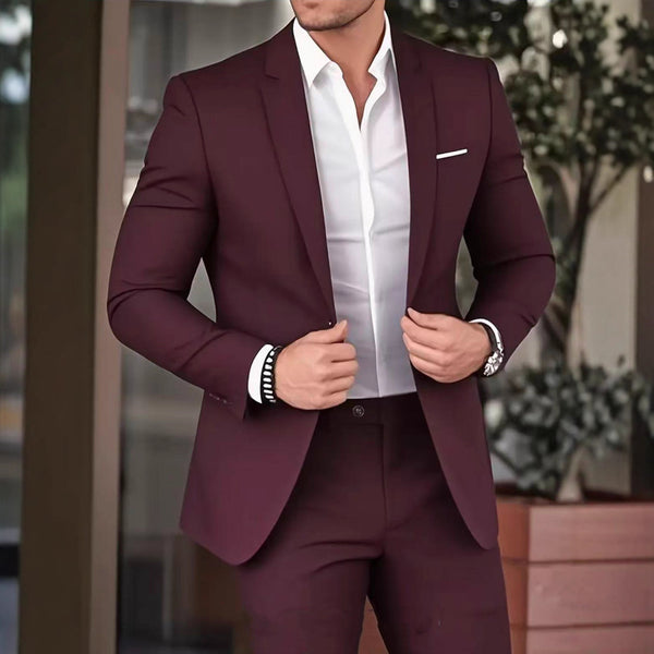 Man wearing a burgundy suit with a white shirt in an outdoor setting
