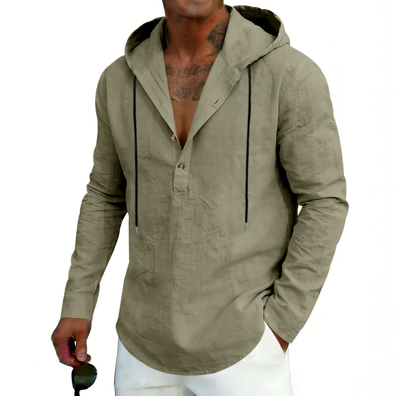 Man wearing a beige hooded shirt with white pants on a white background