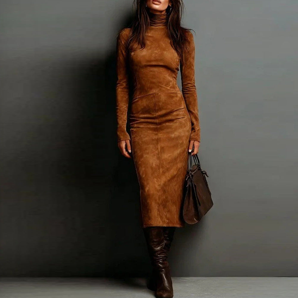 Woman wearing a brown suede dress and boots against a gray background